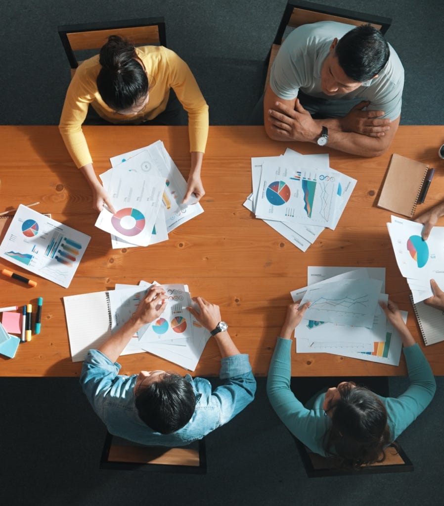 A professional presenting in a bright modern office setting to attentive colleagues.